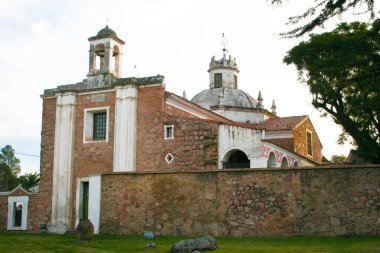 Facade of the Jesuit Estancia de Caroya founded by the Society of Jesus in 1616. Colonia Caroya, Crdoba, Argentina. Rural establishment and church. Colonial structure of cultural and tourist interest clipart