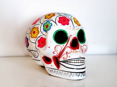 Ceramic skull decorated with Mexican style to commemorate the Day of the Dead. clipart