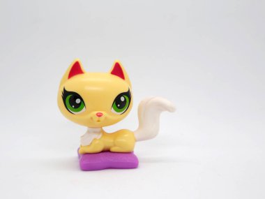 Littlest pet shop. Kitten with big green eyes on her pillow. Toy for girls and boys clipart