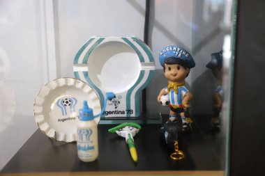 Merchandising of the official mascot of the Argentina 78 World Cup: Gauchito Mundialito. Doll, ashtrays, plate, pen. Kempes Museum, Crdoba, Argentina. clipart