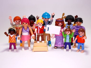 Playmobil toys dolls. People demonstrating. Diversity of people making a claim. People of many races and ages. Blank banner. Grouping of people. Festival. Children and adults. Men and women. clipart