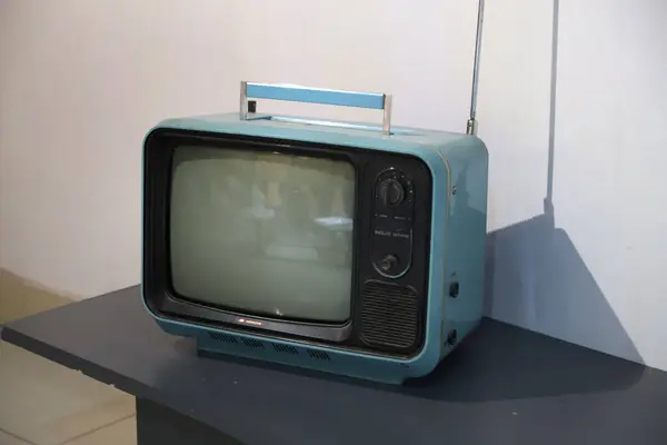 70 'lerin eski Hitachi marka televizyonu. Taşıma kolu ve kanal ayarlama anteniyle. Açık mavi ve siyah retro televizyon. Siyah beyaz TV.