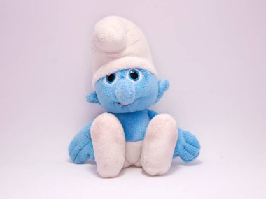 The Smurfs. Clumsy Smurfs. The Smurfs soft toys. Little blue creatures that live in mushroom houses in the woods. Characters from television, movies and comics. Isolated white. Soft toy. clipart