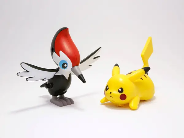 stock image Pokemon Pikipek and Pikachu. New Pokemon of the seventh generation of normal flying type. Woodpecker Pokemon. Lynx and chained sight ability. Toys. Movie characters. Comic. Attack position.