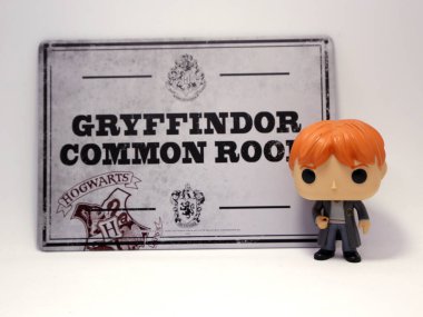 Ron Weasley Funko pop. Toys for kids. Characters of the movie. Gryffindor common room poster. Howards School. Harry Potter's best friend. Character from the J. K. Rowling books. clipart