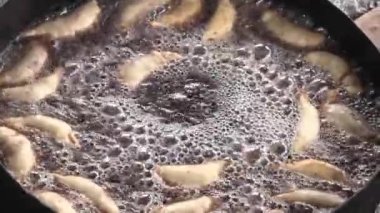 Kreol böreği kızgın yağda pişiyor. Kızarmış börek. Tipik Arjantin yemekleri. Arjantin ulusal bayramları ve tarihleri için geleneksel mutfak.