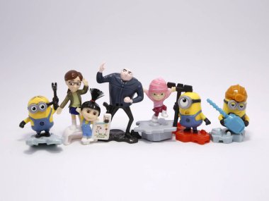 Minions and Gru with his daughters Agnes, Edith and Margo. Minions. Gru. Villain Gru. Family of Gru. Characters from the famous Despicable Me movies. Kinder Egg Toys. clipart