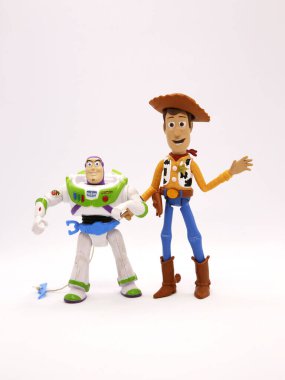 Toy story movie. Woody and Buzz Lightyear. Pixar and Disney movie toys. Cowboy and astronaut. I will be your faithful friend. Isolated white. Hat in hand. Vertical format. clipart