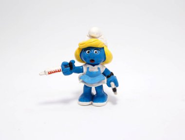 Smurfette. Nurse Smurfette. The smurfs. Girl smurf. Little blue creatures that live in mushroom houses in the woods. Television characters, movies and comics. Blue. Nurse for giving a vaccine. clipart