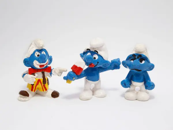 stock image The smurfs. Grumpy Smurf. Clown smurf. Gourmand Smurf. Little blue creatures that live in mushroom houses in the woods. Television characters, movies and comics. Blue creatures. Angry.