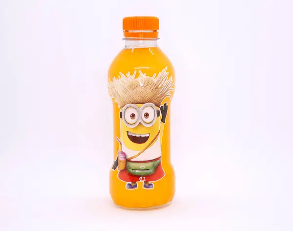 Minion karakterli bir şişe. Bir şişe portakallı soda. Filmlerdeki köleler. Ünlü Despicable Me filmlerinden bir karakter. Kılık değiştirmiş köleler. İçecekler. Ticari işler. İzole edilmiş beyaz.