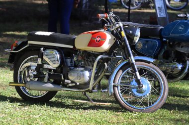 Gilera and Puma brand motorcycles. Old motorcycles at an outdoor classic vehicle exhibition. clipart