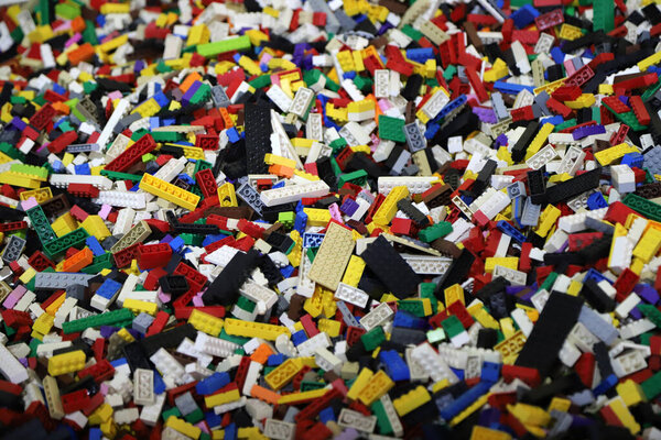 Horizontal background of a large number of children's toy building blocks in various colors
