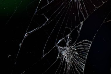 Kırık camların detaylı dokusu, bozuk telefon ekranı, siyah arka planda..