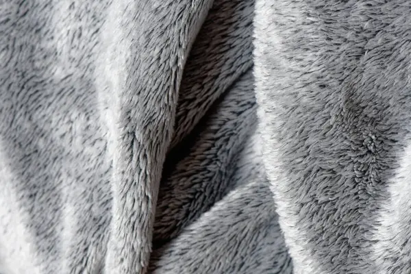 Soft gray fleece material. Warm delicate plaid fabric, fabric texture with folds and wrinkles