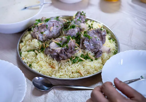 stock image mansaf and jameed served on table, with copy space