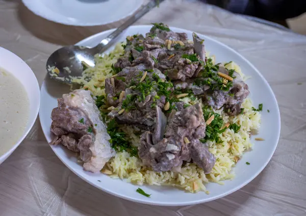 stock image mansaf and jameed served on table, with copy space