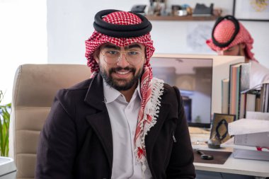 portrait for arabic male during work in office with smile on his face clipart