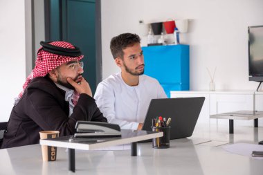 Arab males in meeting during work with copy space clipart