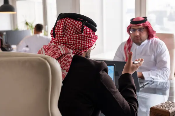 Stock image meeting between two arabs talking about work details