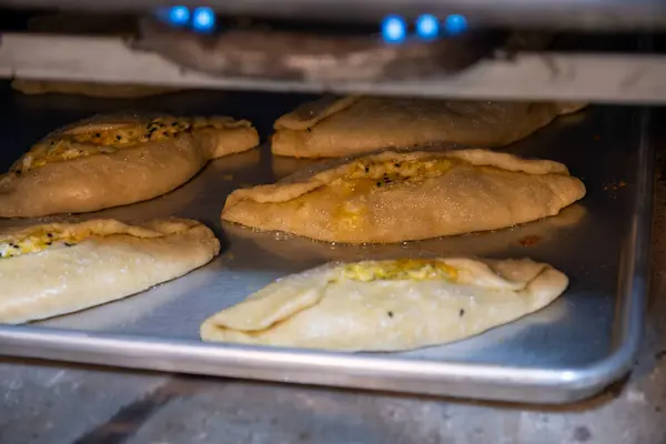 stock image Pastries in oven being baked and freshly made of flour, olive oil and cheese, made according to jordan and palestine way