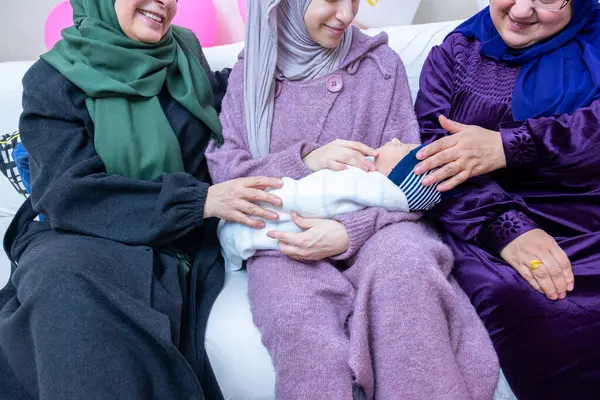 stock image Females are celebrating new baby and holding it indoors, holding gifts and balloons are around