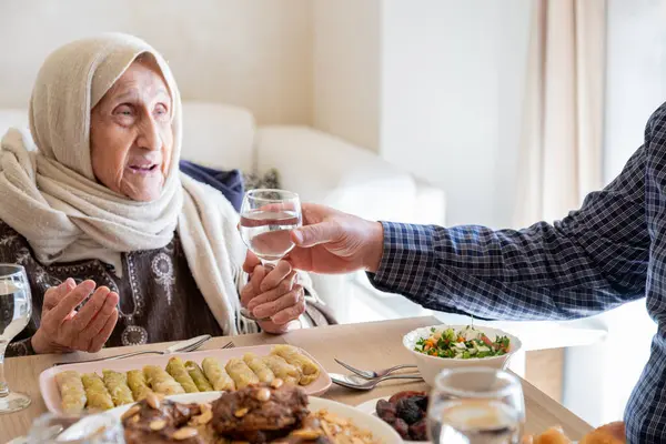 stock image Family eating together with multi generation members in modern living room