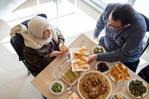 stock image Family eating together with multi generation members in modern living room