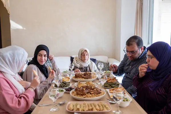 Stock image Family eating together with multi generation members in modern living room