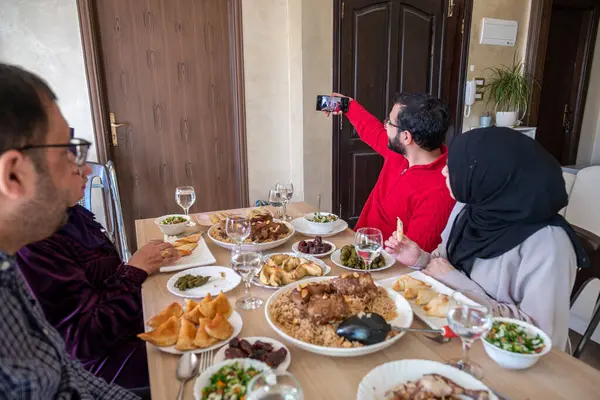 stock image Family taking selfie together while having dinner