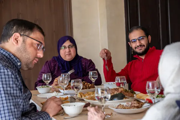 stock image Family eating together with multi generation members in modern living room