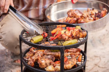 Zurbian dinner. The barrel has been uncovered and it is ready and well cooked. It contains chicken, vegetables and rice. It is placed on a wire rack and it has been transferred to the serving tray. clipart