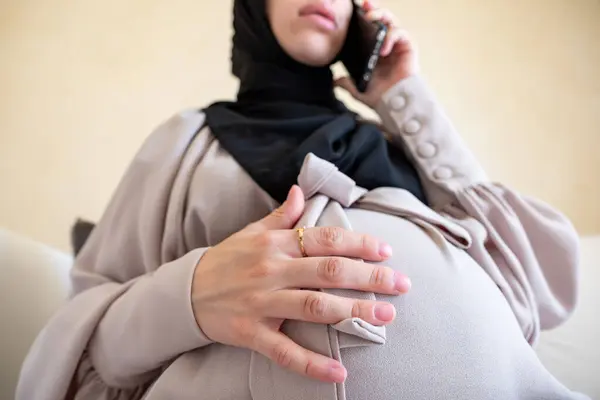 stock image Arabian muslim pregnant female making phone call