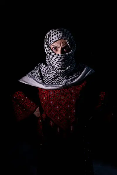 stock image plastanina woman wearing traditional clothes with white keffiyeh on dark background