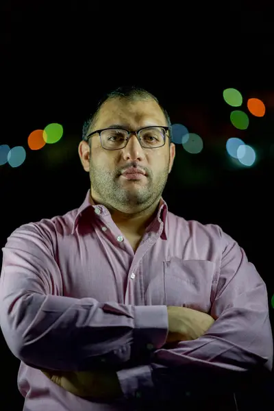 stock image male portrait wearing shirts and glasses with blurred lights in the  background