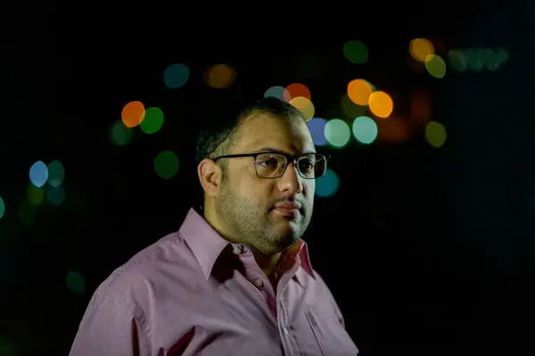 stock image male portrait wearing shirts and glasses with blurred lights in the  background