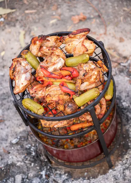 stock image Zurbian dinner. The barrel has been uncovered and it is ready and well cooked. It contains chicken, vegetables and rice. It is placed on a wire rack and it has been transferred to the serving tray.