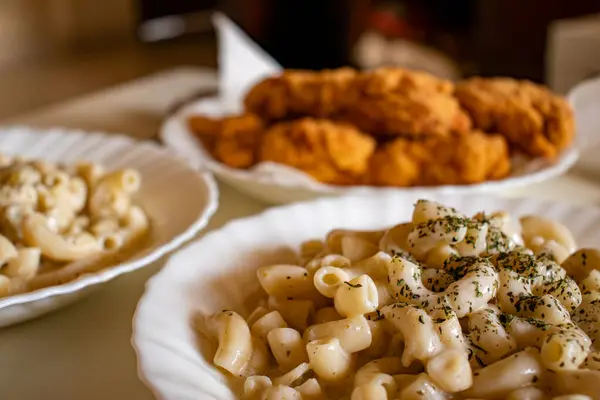 stock image macaroni served with chicken nugget on table topped with spices and herbs with cream sauces and called bechamel