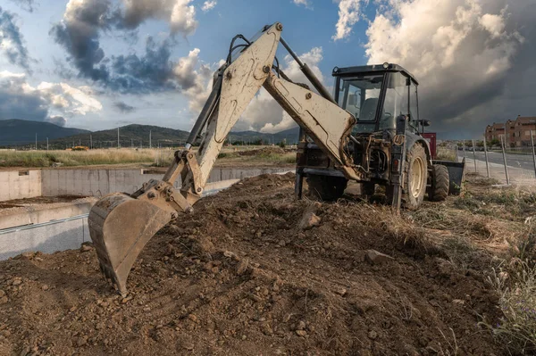 Excavator at a construction site, moving earth