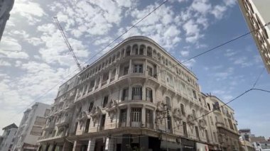 Majestic white building standing tall under a cloudy sky in Casablanca, Morocco