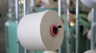 Arabalarda kumaş dokuma. Fabrikadaki ipliklerden kumaş üretimi. Tekstil fabrikası endüstrisi. Kumaş yapan makineler. Fabrikada iplik döndürme makinesi. Endüstriyel iplik dönüyor. Fabrika ortamında otomatik iplik üretimi