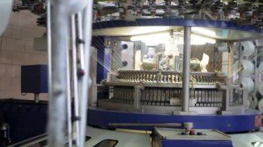 Arabalarda kumaş dokuma. Fabrikadaki ipliklerden kumaş üretimi. Tekstil fabrikası endüstrisi. Kumaş yapan makineler. Fabrikada iplik döndürme makinesi. Endüstriyel iplik dönüyor. Fabrika ortamında otomatik iplik üretimi