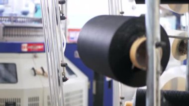 Arabalarda kumaş dokuma. Fabrikadaki ipliklerden kumaş üretimi. Tekstil fabrikası endüstrisi. Kumaş yapan makineler. Fabrikada iplik döndürme makinesi. Endüstriyel iplik dönüyor. Fabrika ortamında otomatik iplik üretimi