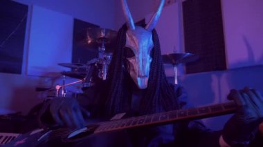 Şeytan canavar gitar çalıyor. Karanlık bir stüdyoda maskeli gizemli bir adam. Korku, Cadılar Bayramı, Cehennem