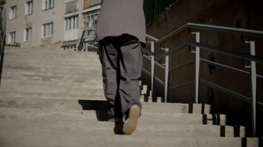 Kız şehir caddesinde serin kanlı hip-hop dansı yapıyor. Bir dansçı bir şehir evinin yakınında dans eder. Gri gömlekli kadın merdivenlerde numaralar yapıyor. Merdivenlerde gösteriş yapan kız. Merdivenlerde gri tişörtlü bir sokak sanatçısı. Gri gömlekli bir kadının merdiven numaraları..
