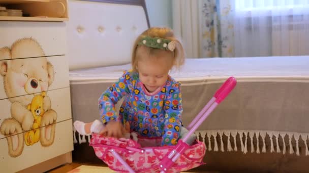 Young Girl Happily Playing Pink Stroller Doll Bedroom Child Playing — Stock Video