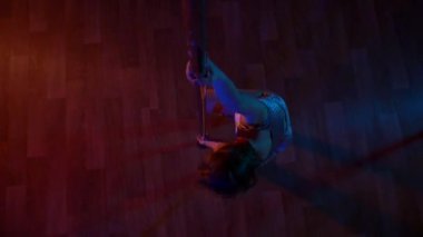 Seksi kadın disko kulübünde direk dansı yapıyor. Direğin üstünde erotik dans. Egzotik direk dansı, striptizci, direk sporu, direk sanatı. Dansçı bir direğin etrafında kıvrılır ve döner. Baştan çıkarıcı striptizci akışkan hareketleriyle gölgelerde büyülenir..