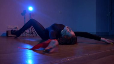 Kadın enerjik bir şekilde dans ediyor ve baştan çıkarıcı bir dans yapıyor. Dans eden kız ve yüksek topuklu ayakkabı. Erotik dans eden genç bir kadın. Külotlu ve bluzlu bir kadın dans ediyor. Vahşi saçlı ve çarpıcı dans hareketleri olan bir kadın, büyüleyici bir ilgi.. 