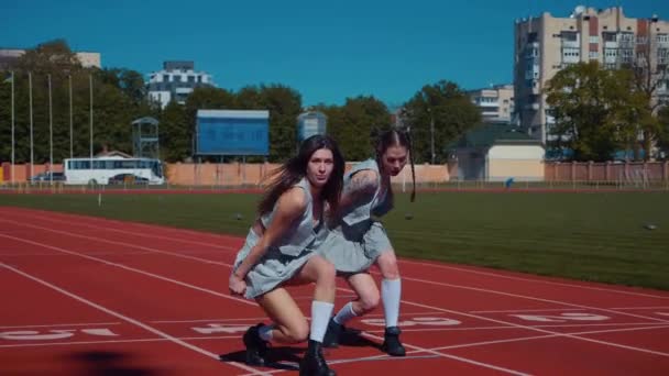 Two Fiery Women Joyfully Dancing Stadium Track Slow Motion Shooting — Vídeo de stock