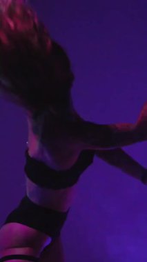 Dikey. Seksi kadın disko kulübünde direk dansı yapıyor. Direğin üstünde erotik dans. Egzotik direk dansı, striptizci, direk sporu, direk sanatı. Duman makinesi, lazer..